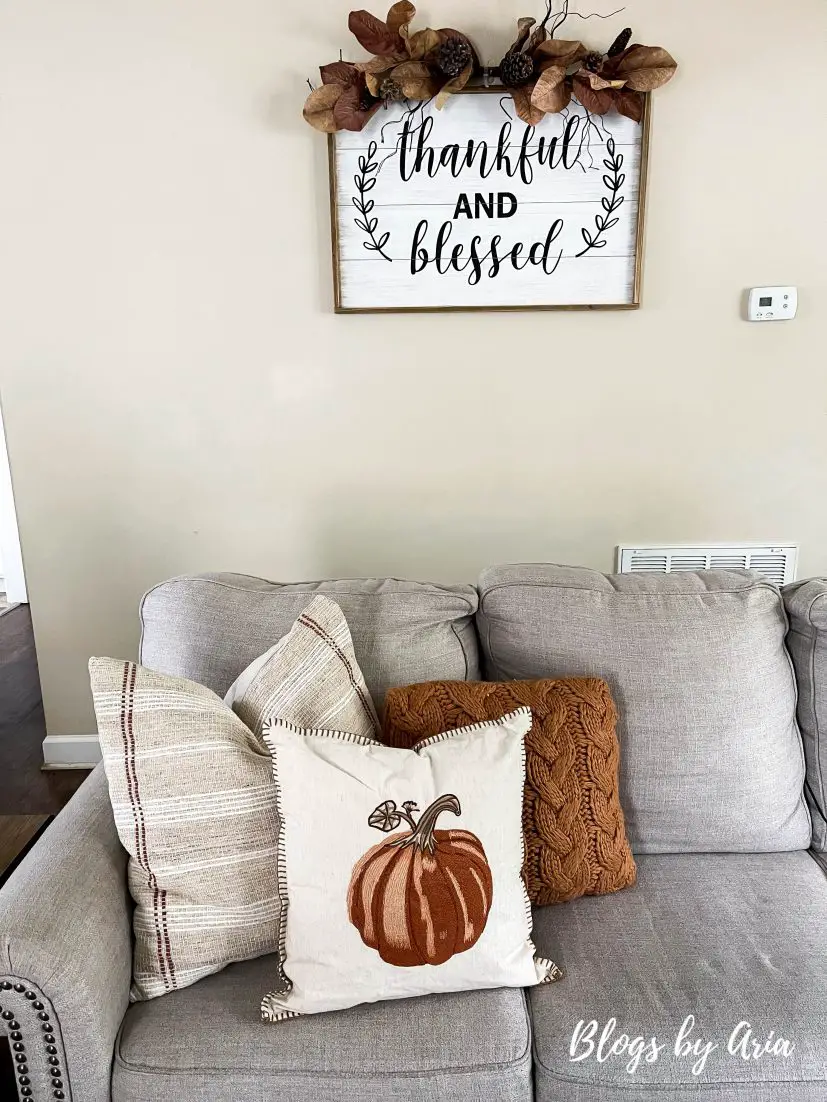 early Fall decorating ideas with neutral textured pillows and pumpkin pillows