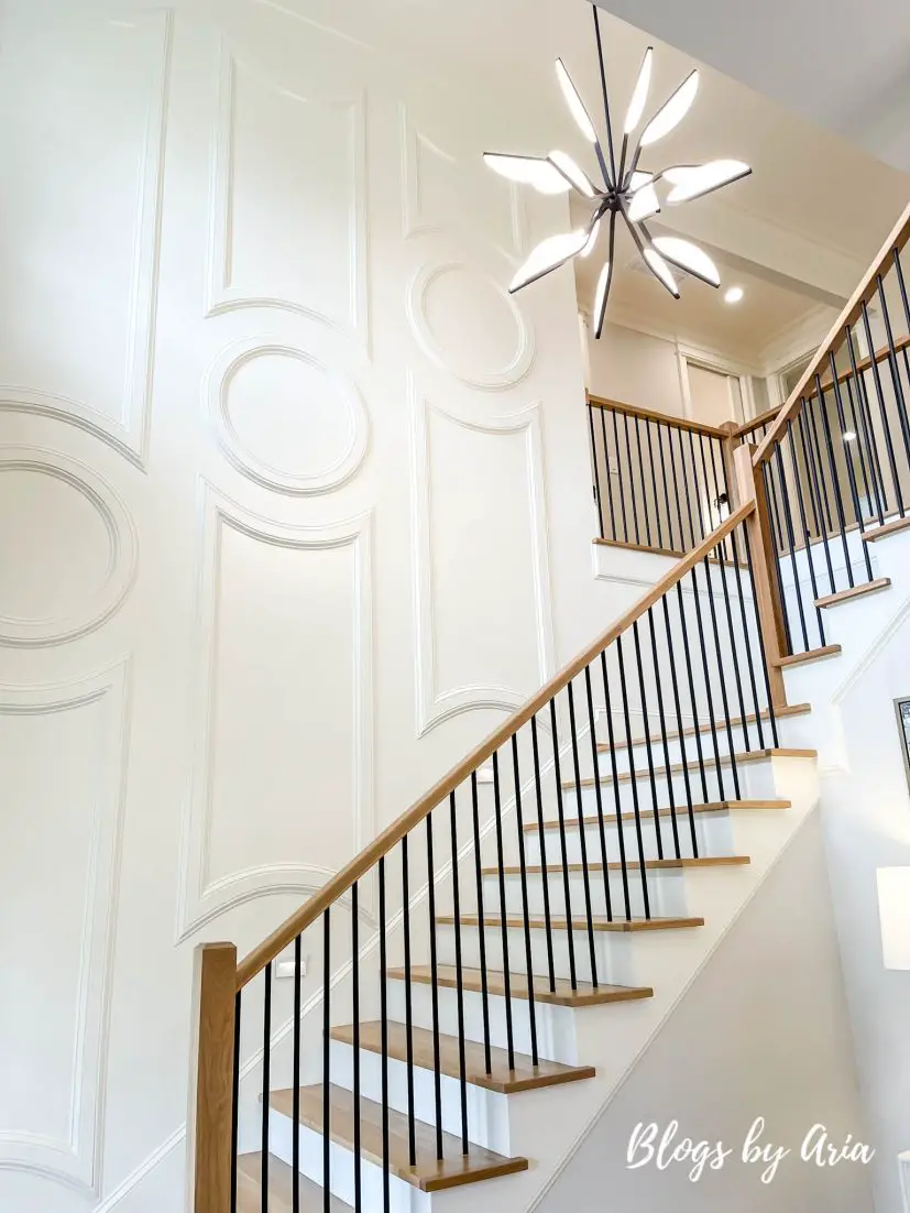stairway with white circle trim accent molding