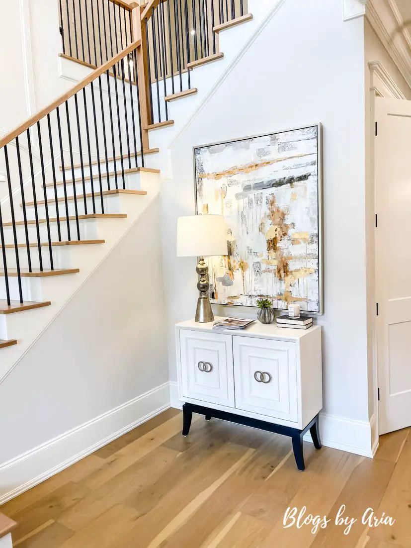 foyer decorated with white modern cabinet and wall art