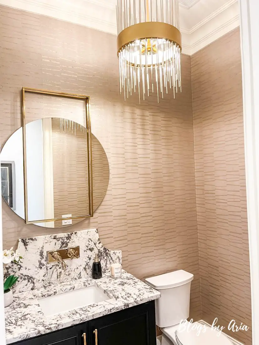 powder room with champagne textured wallpaper