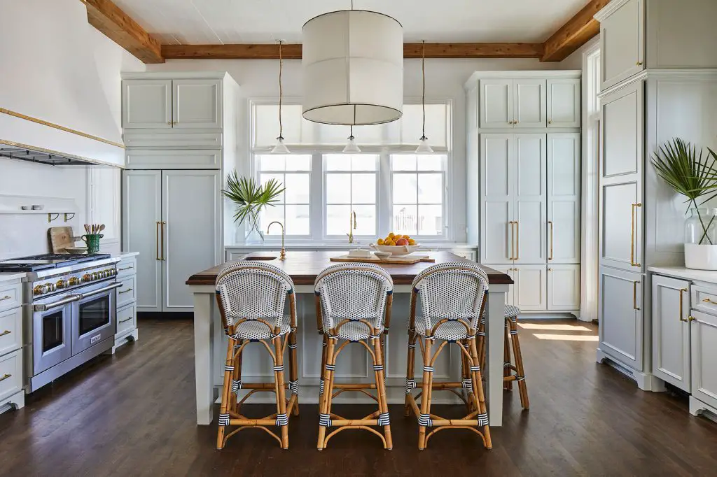 large white kitchen with woven barstools
