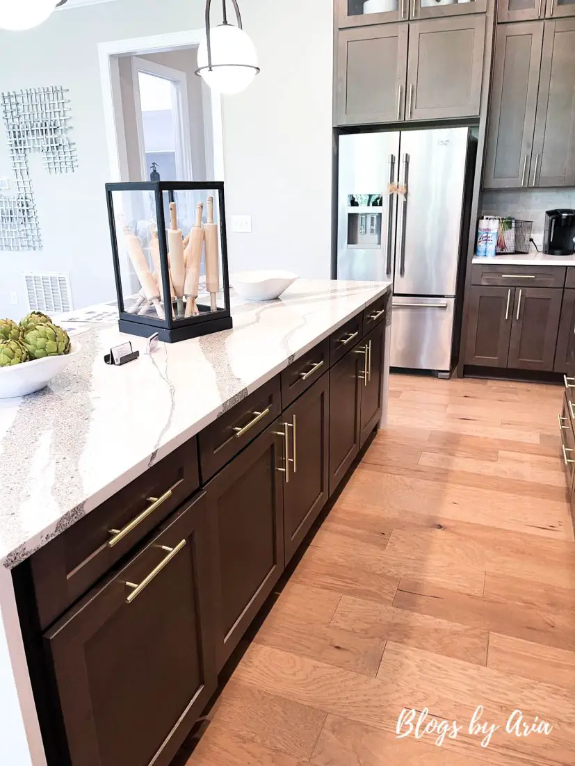 The Statesville model by Caruso Homes kitchen with 9 foot quartz waterfall gourmet kitchen island