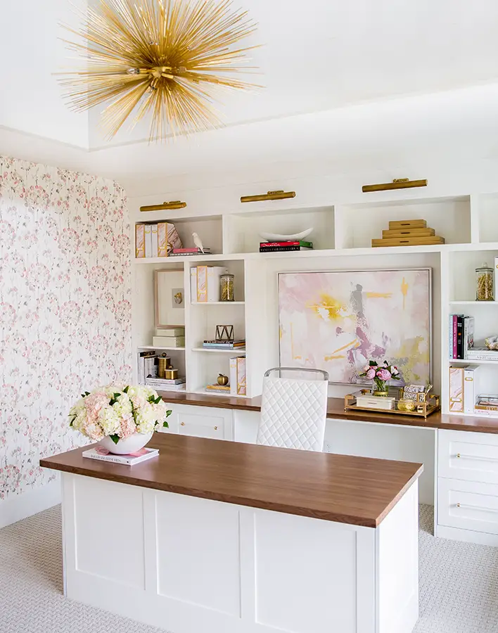 feminine home office design with built ins and pink wallpaper