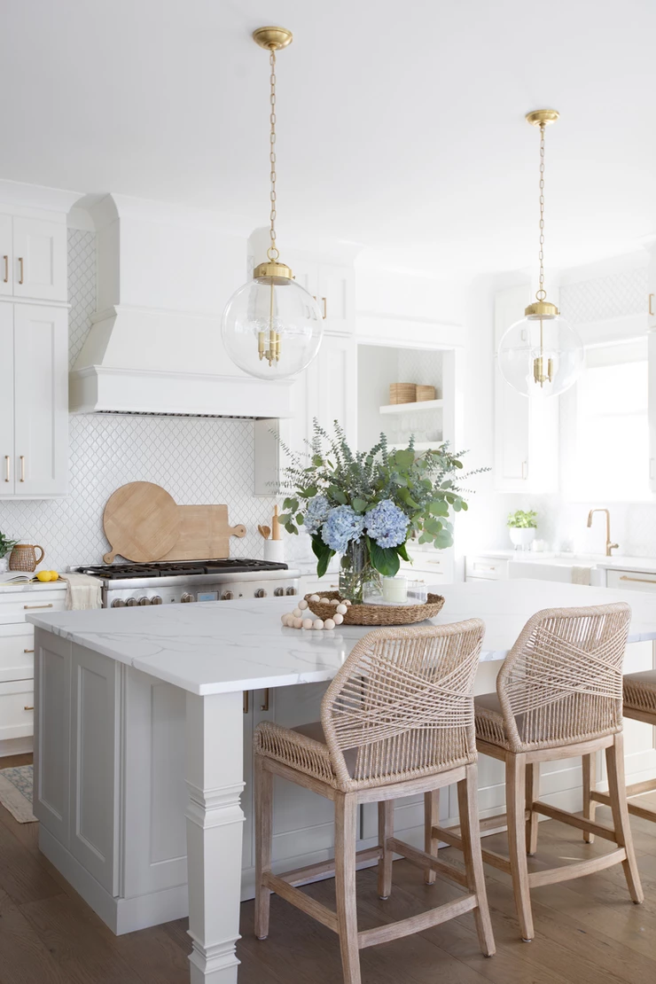 coastal white kitchen with woven counter chairs