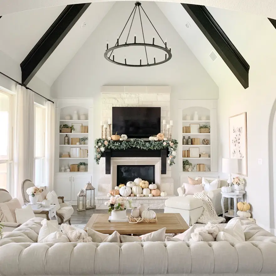 neutral fall decorated living room with white and muted color pumpkins