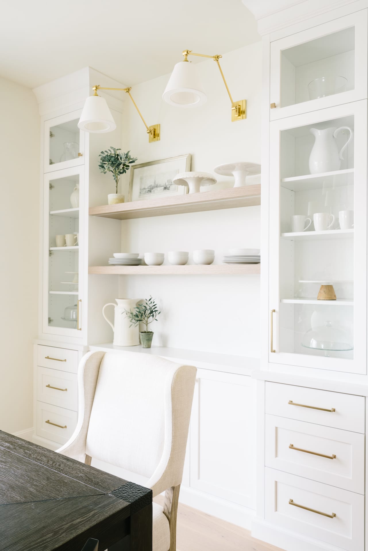 white office built in cabinets and floating shelves