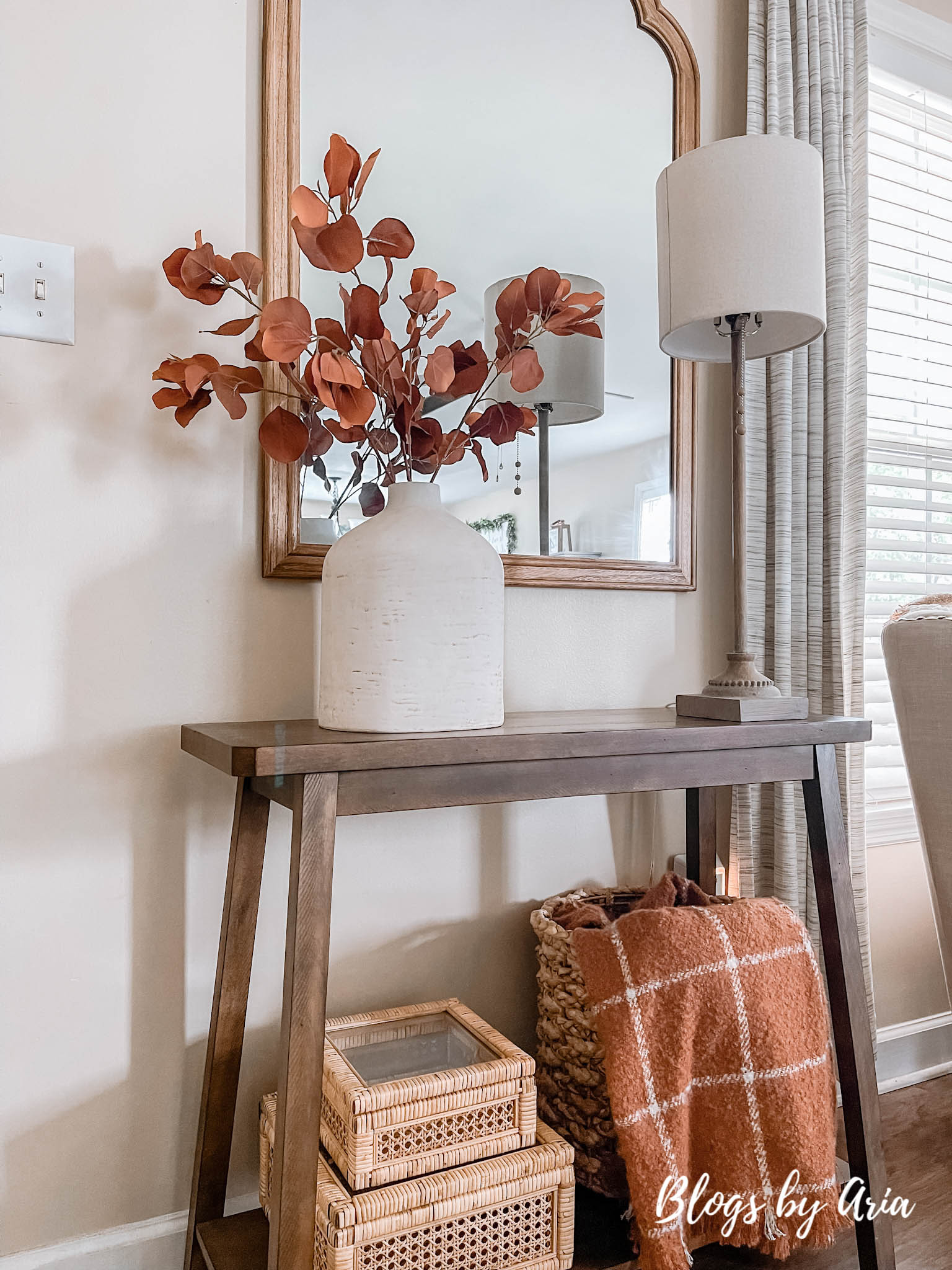 fall entryway small space entryway decorating for Fall with cream vase filled with beautiful brown stems and window pane fall throw blanket in basket