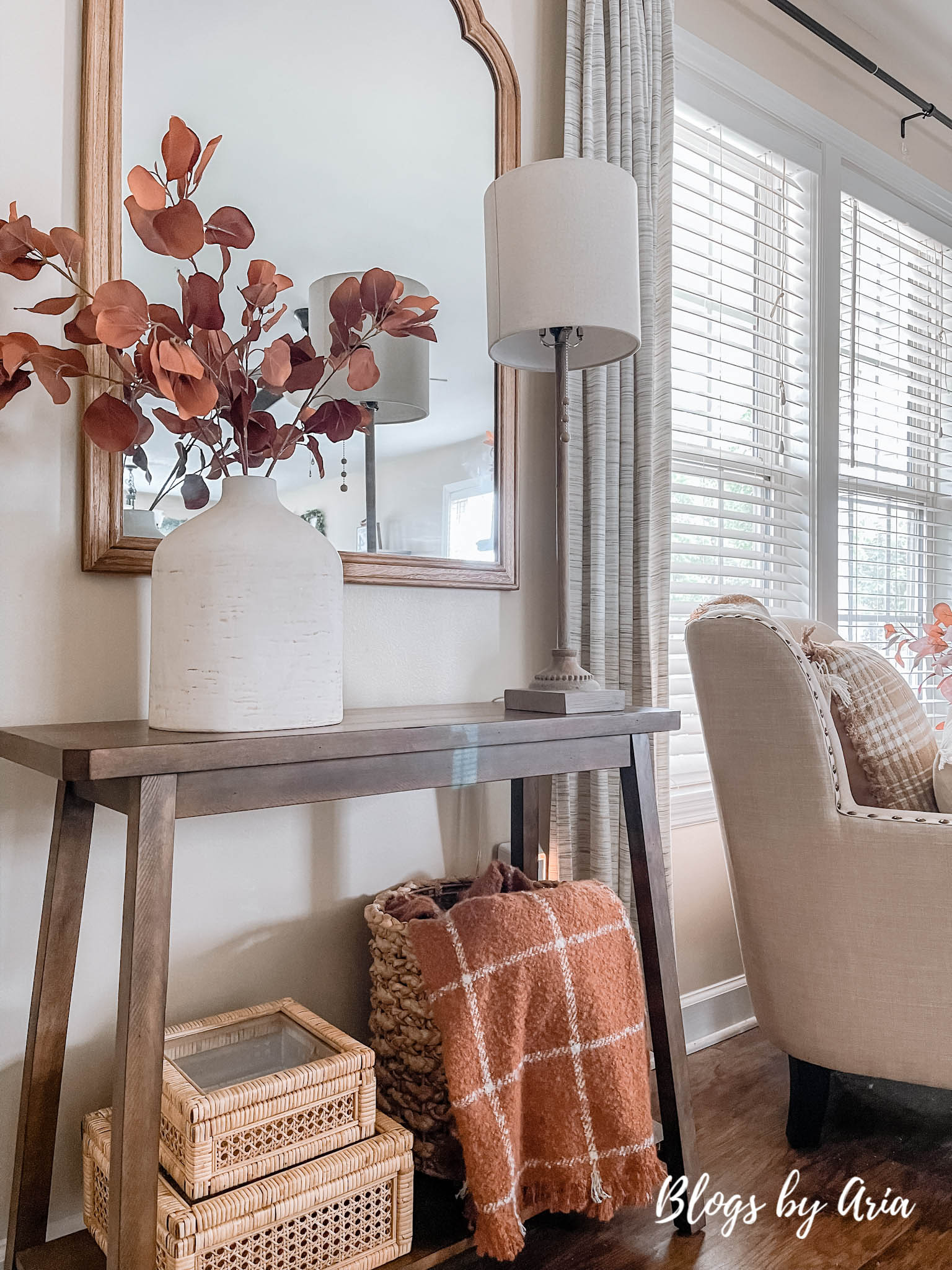 fall entryway small space entryway decorating for Fall with cream vase filled with beautiful brown stems and window pane fall throw blanket in basket