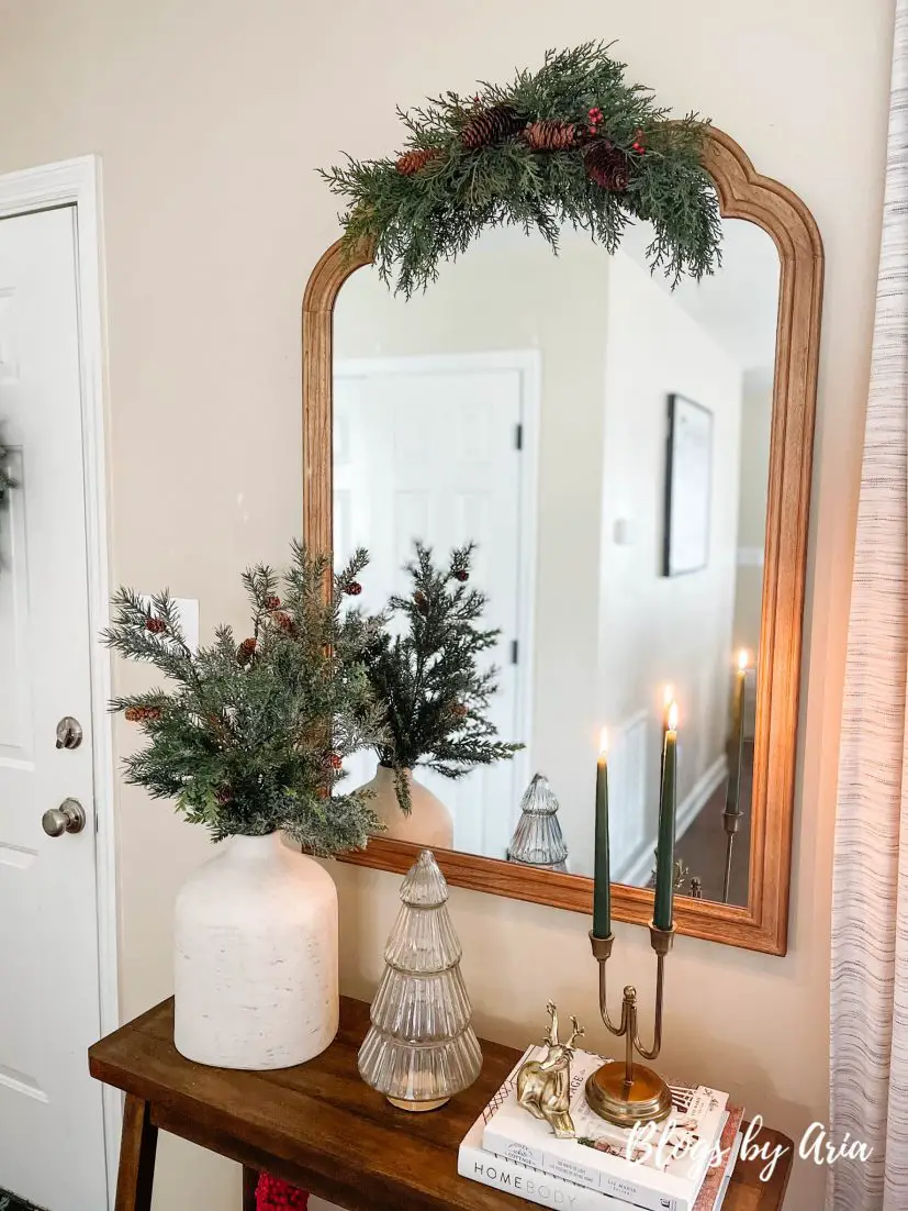 neutral Christmas entryway with green, gold and a pop of red