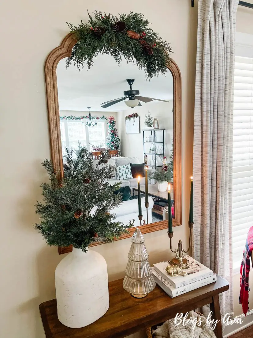 neutral Christmas entryway with green, gold and a pop of red