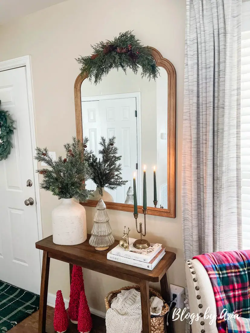 neutral Christmas entryway with green, gold and a pop of red