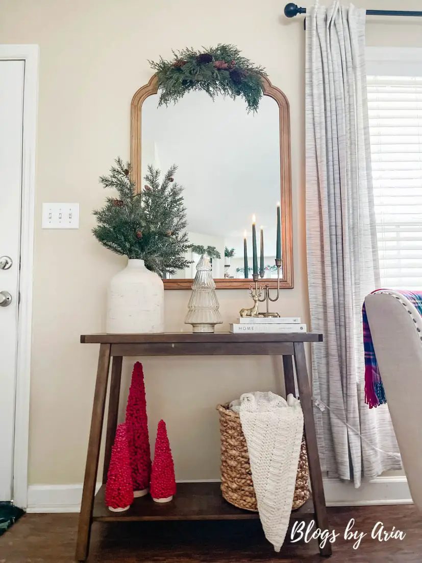 neutral Christmas entryway with green, gold and a pop of red